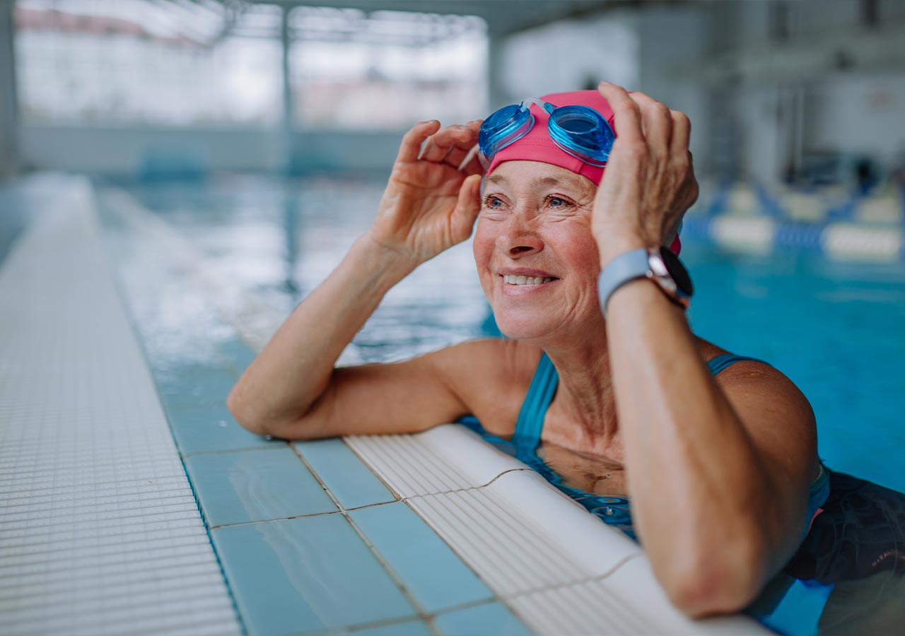 Older women in a pool with goggles on